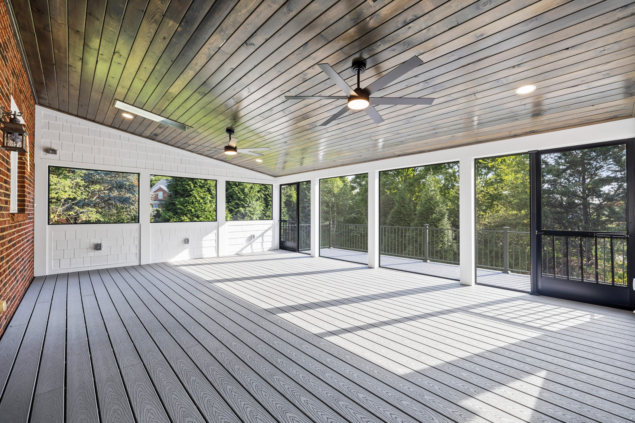 Amberset covered composite deck interior with black aluminum baluster railings