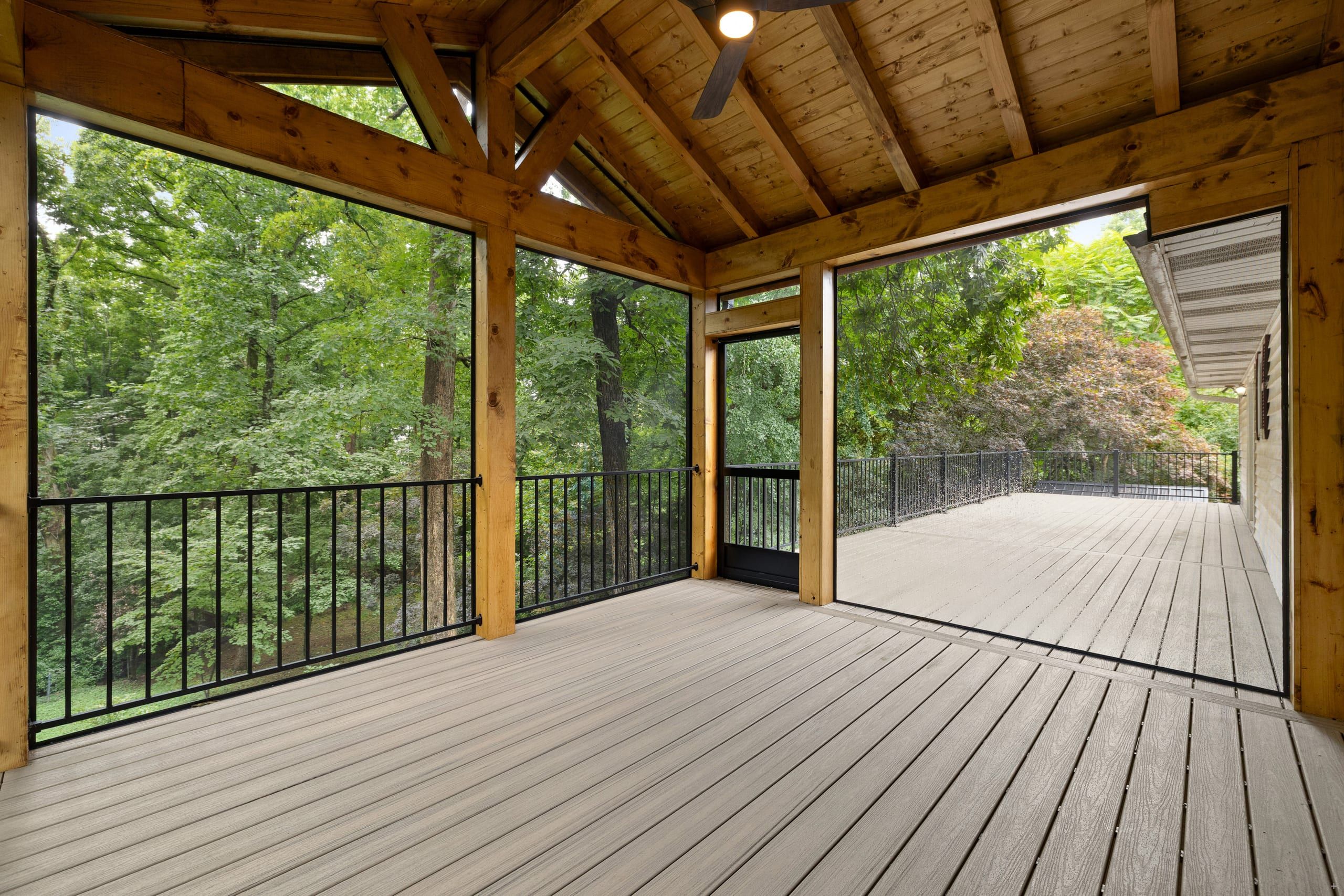Venice covered screened porch with vaulted wood ceiling opening onto an elevated composite deck