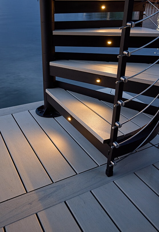 Close-up of Trex Spiral Stairs Summit composite treads and railing at twilight